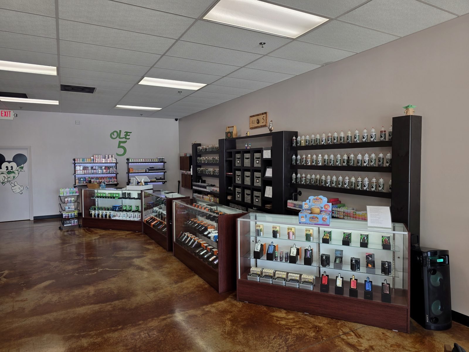 Display cases of mods, tanks and pod systems at the Ole 5 Vapor counter